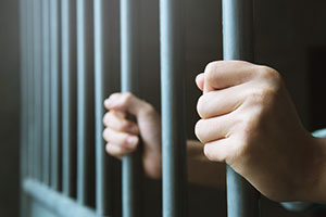 Prisoners hands on bars